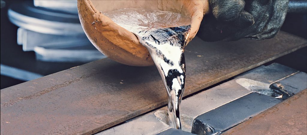 Pouring molten aluminum into a mold