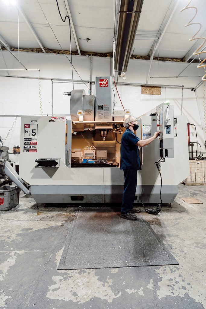 Ermak machine shop technician programming the Haas VF Series CNC vertical machining center